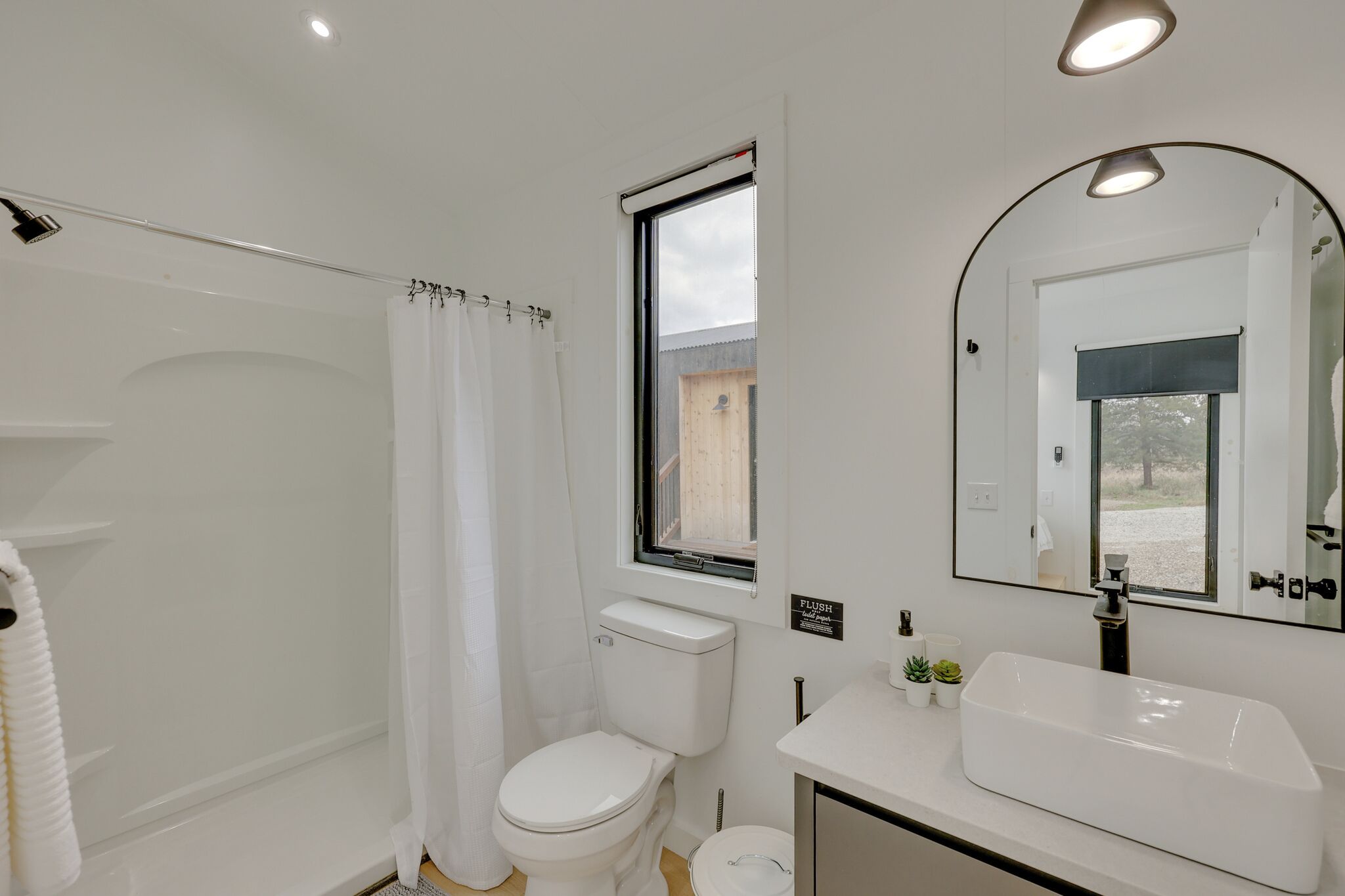 A modern bathroom with a bathtub, toilet, and sink.