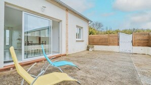 Una casa moderna con un ventanal de vidrio que da a un patio.