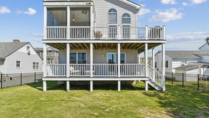 A two-story house with a balcony and a covered porch.