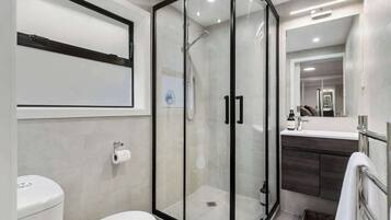 Shower, hair dryer, towels, shampoo