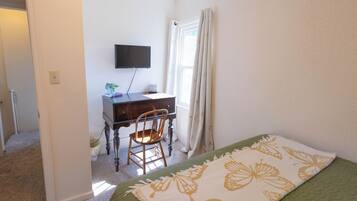 Une chambre à coucher avec un lit, un bureau et une chaise.