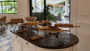 A dessert buffet with various pastries and cakes on wooden stands. - Le Palais d'Akwa (Abidjan)