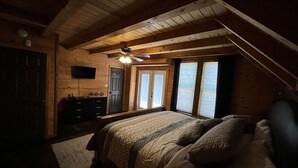 Un dormitorio con cama, cómoda y ventilador de techo.