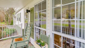 A covered porch with a wooden chair and a potted plant. - Riverfront Tennessee Retreat w/ Patio & Boat Ramp! (Elizabethton)