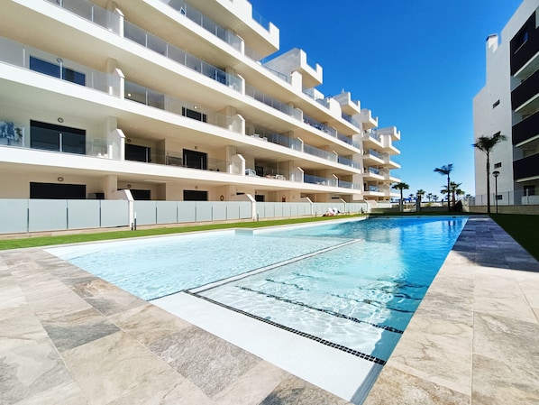 Enjoy a refreshing swim in the hotel's large, rectangular pool surrounded by a spacious deck.