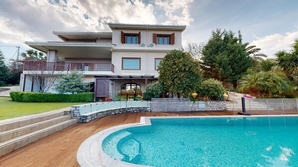 Enjoy a refreshing swim in the pool surrounded by a beautifully maintained garden and a modern architectural design.