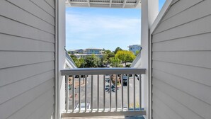 A balcony with a view of a residential area, including houses and parked cars. - Cassine Gardens 189 (Santa Rosa Beach)