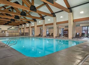 Relax by the pool surrounded by lounge chairs.