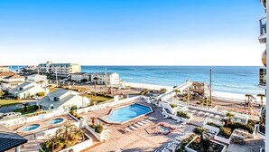 A resort with multiple swimming pools, a beach area, and ocean views. - Surfside Resort #505 (Miramar Beach)