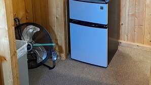 A compact kitchenette with a microwave, a small refrigerator, a coffee maker, and a fan. - Lodge Room #7 - Montana Mountain Views (Butte)
