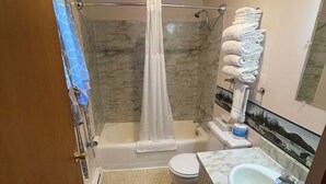 A bathroom with a bathtub, toilet, and sink. - Lodge Room #7 - Montana Mountain Views (Butte)