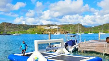 A SUPPERVOLLEY boat docked at a marina with a clear blue sky and calm water.