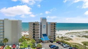 A hotel named Ocean Breeze East with a pool, parking lot, and beach view. - Ocean Breeze East 803 (Pensacola)