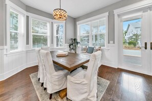 Enjoy meals in this dining area with a wooden table and comfortable chairs.