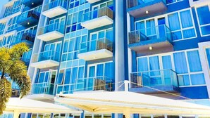 A modern high-rise building with multiple balconies and large windows. - Luxury 1BR 55sqm 1 Pacific MactanNewtown (Lapu-Lapu)