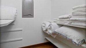A small, compact room with a bunk bed, a small window, and a wooden floor.