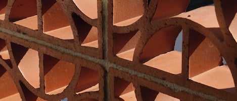 A close-up of a brick wall with a geometric pattern.