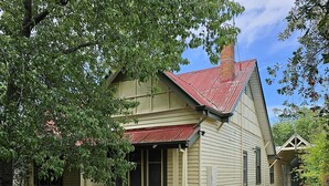 A two-story house with a red roof, beige siding, and a front porch. - Ruston House - Port of Echuca (Echuca)