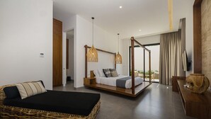 A modern bedroom with a large bed, a smaller bed, a wicker sofa, and a wooden bench.