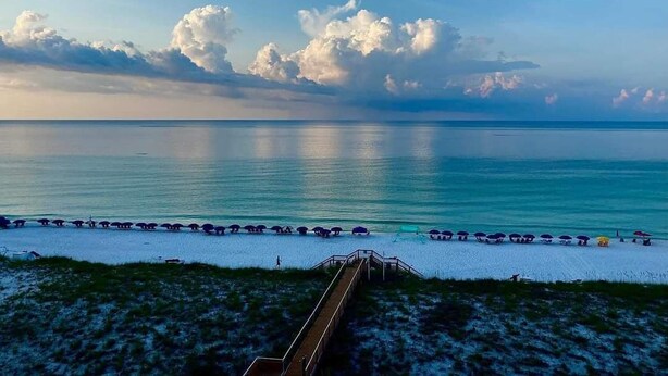 A beach with umbrellas and a wooden walkway leading to the water. - Affordable stay 7 minutes to the beach 2021 32' RV (Navarre)