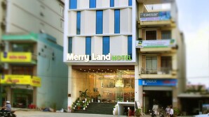 A modern hotel with a grid-like facade and a prominent sign reading "Merry Land HOTEL". - Merry Land Hotel Da Nang (Da Nang Municipality)