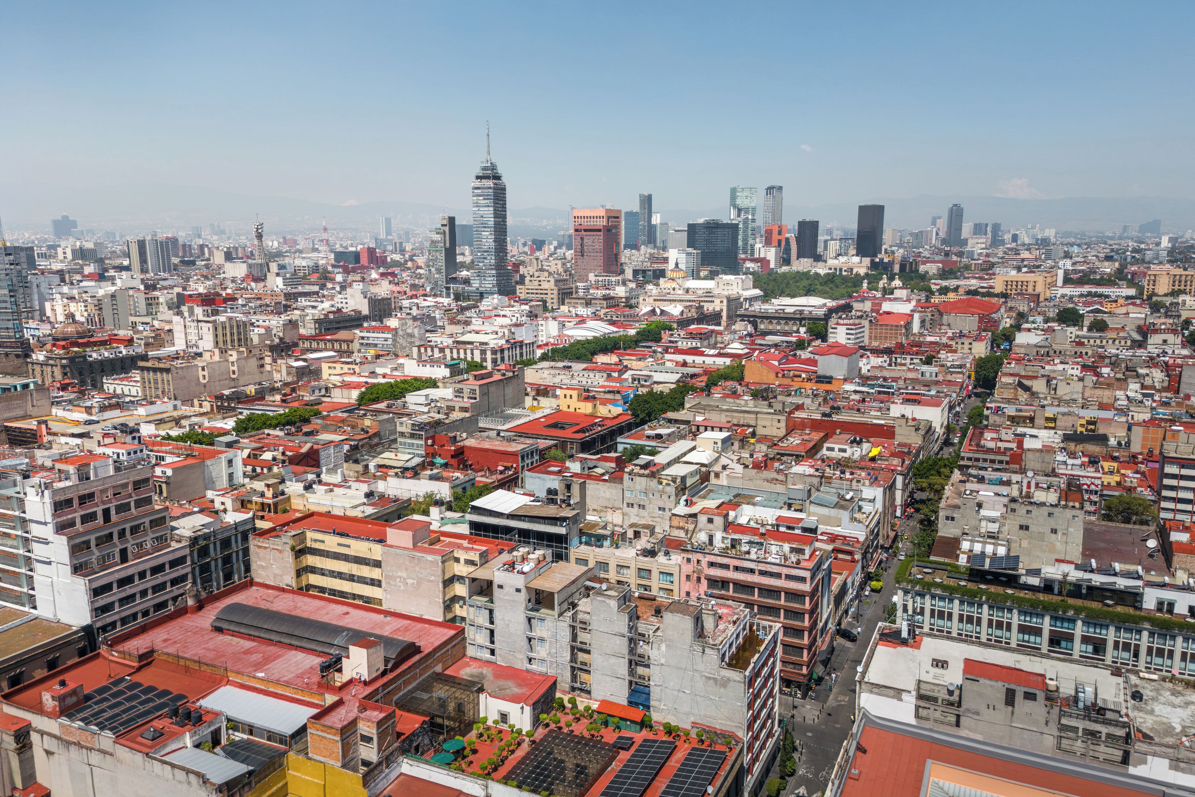 A densely packed urban area with a variety of building styles, including modern skyscrapers and older, smaller structures.