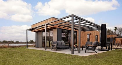 The six-person holiday villa Amalia with private sauna has a spacious living room, open kitchen, three bedrooms and a spacious patio.