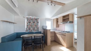 A compact kitchen with a dining area, a built-in stove, and a microwave.