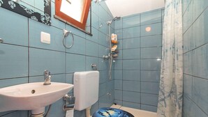 A bathroom with a sink, toilet, and shower. - Studio with sea view and air conditioning (Peroj)