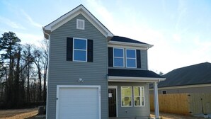 A two-story house with a garage, a covered porch, and a fenced backyard. - Brand NEW Entire home in Statesville, NC (Statesville)