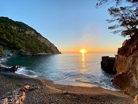 A coastal sunset view with rocky cliffs and calm sea.. Holiday Home 'Can Quintaneta' with Terrace Overlooking Begur Castle
