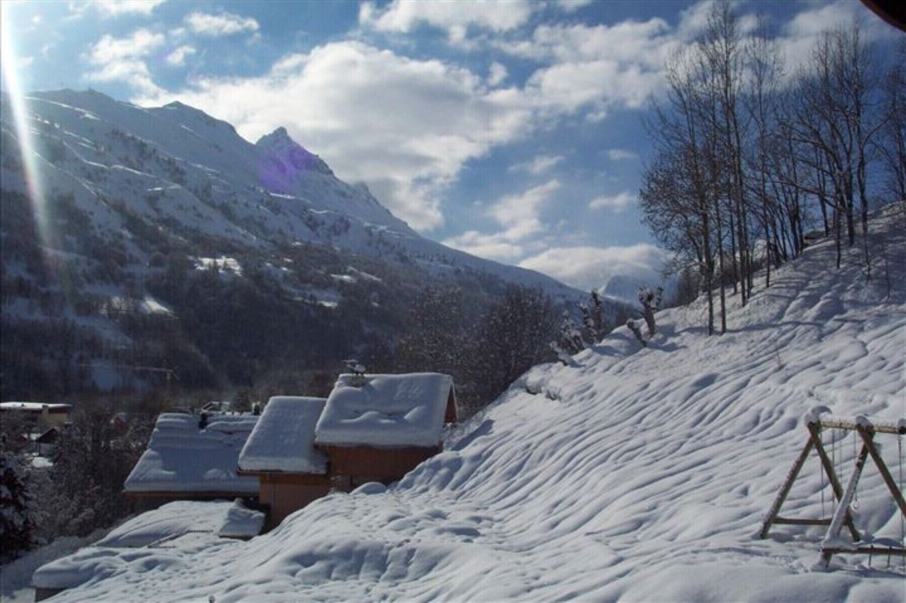 A snow-covered mountain landscape with a clear sky.