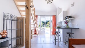 Un intérieur moderne comprenant un escalier, un coin cuisine et un lit.