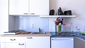 Une cuisine moderne équipée d’un plan de travail, d’un évier et d’un lave-vaisselle.