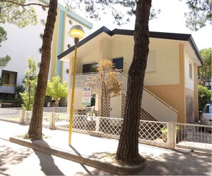 Stylish real estate office with a two-story facade and a charming garden setting.