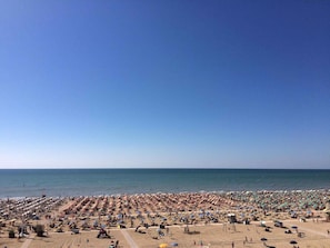 Enjoy a spacious beach area with rows of umbrellas and sun loungers, perfect for group activities or events.