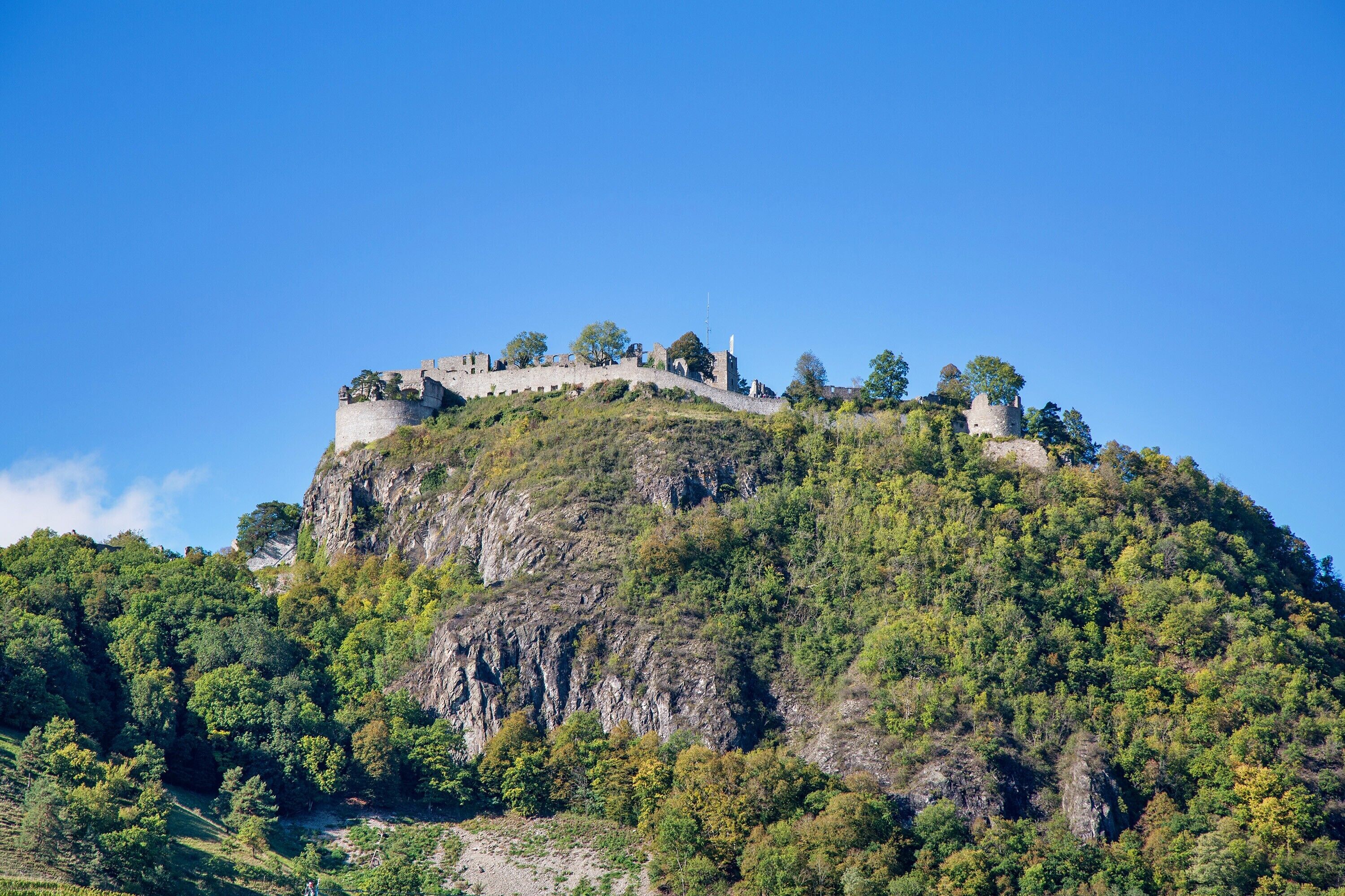 A castle on a hill with a clear sky.