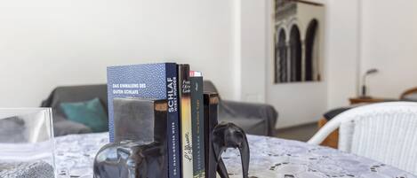 A room with a table displaying books and a decorative elephant figurine.