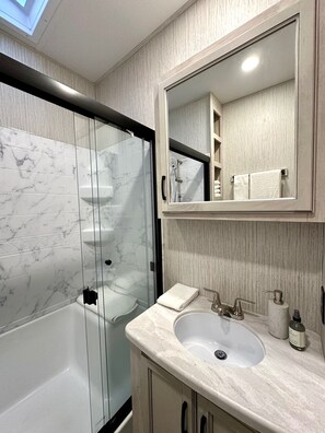 Shower, towels, soap, toilet paper