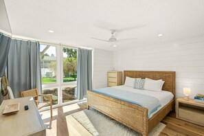 A bedroom with a large bed, a desk, a chair, a nightstand, and a window with curtains. - Walk to Lido Beach & St. Armands! Heated Pool/Spa (Sarasota)