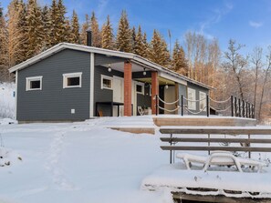A building with a grey exterior, a wooden deck, and a snow-covered ground. - Brofeldt by Interhome (Tohmaj ärvi)