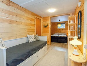 A compact room with a bed, a sofa, a small table with a lamp, and a window with a view. - Brofeldt by Interhome (Tohmajärvi)