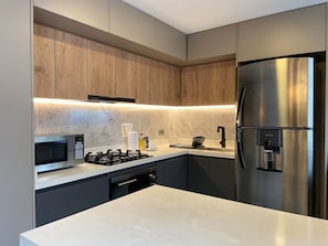 Fridge, microwave, stovetop, coffee/tea maker
