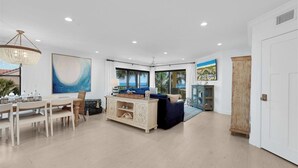 A spacious living room with a dining area, large windows, and a view of the outdoors. - 3 bedroom Ocean Front with amazing ocean views! (Saint Augustine)