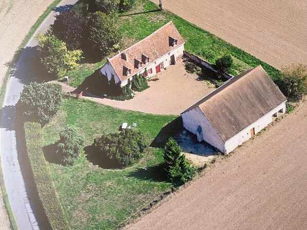 An aerial view of a rural property with two main buildings, a fenced yard, and a river nearby. - Charming cottage with pool, pets allowed, perfect for families (Thoré-la-Rochette)
