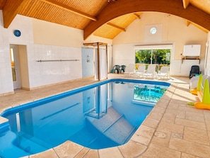 An indoor swimming pool with a tiled floor, a wooden ceiling, and a view of the outdoors. - House with private heated pool, pets allowed near Loire castles (La Chapelle-Saint-Martin-en-Plaine)