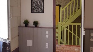 A staircase with green railings leading to a lower level.