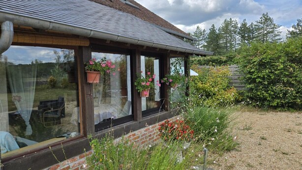 A house with a brick exterior, large windows with potted plants, and a gravel yard. - Charming Restored Barn with Tennis, Near Loire Castles & ZooParc de Beauval, Pet-Friendly, Sleeps 3 (Cheverny)