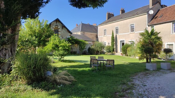 A traditional stone building with a well-maintained garden, a patio with chairs, and a gravel path leading to the entrance. - Cozy studio with shared garden and parking, ideal for couples facing Pontlevoy Abbey (Pontlevoy)