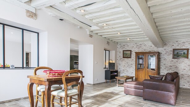 A spacious living area with a dining table, chairs, a sofa, and a cabinet. - Charming Cottage in Cheverny with Garden and Garden Furniture (Cheverny)